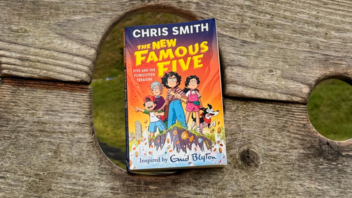 Image of a New Famous Five book in the wooden stocks at Corfe Castle